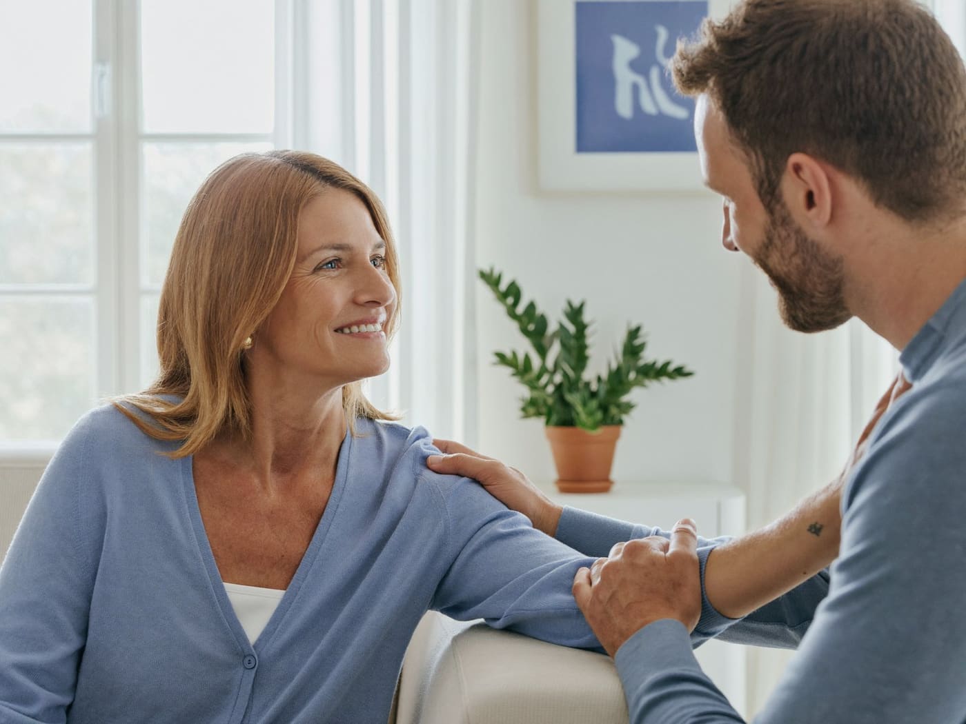Someone listening with care to a loved one at home