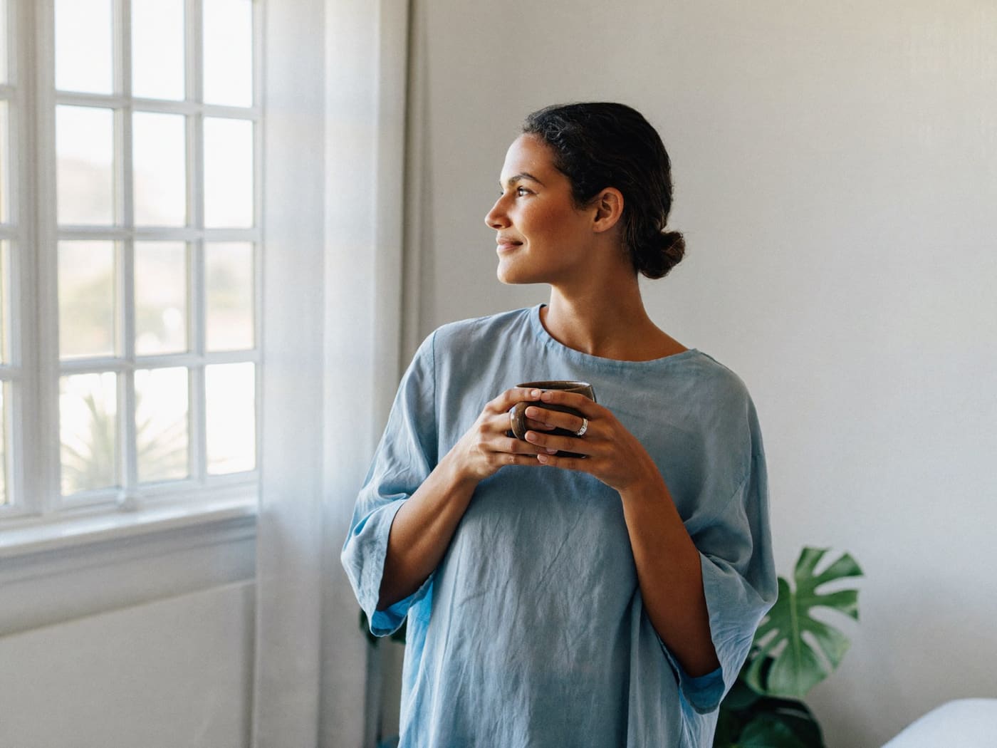 A calm, hopeful moment by a bright window